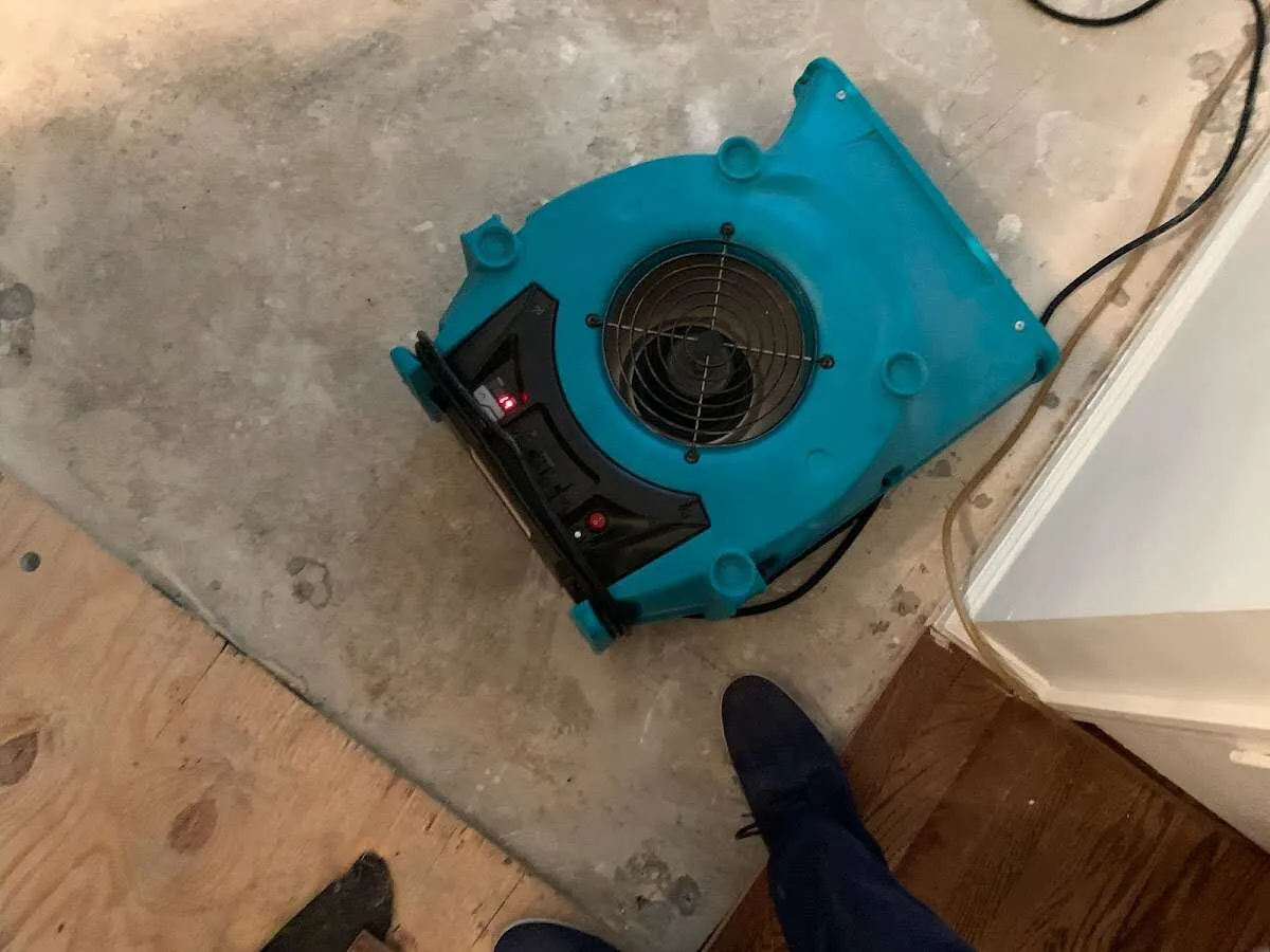 Air mover drying subfloor during Commercial Water Damage Restoration in Fort Smith